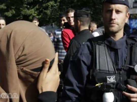 Police officer and woman wearing niqab - national security