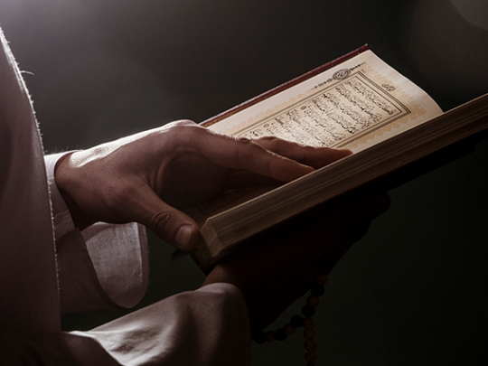 A man holding Qur'an the greatest miracle ever sent from God.